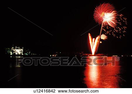 Stock Image -  fireworks, Thousand Islands, NY, Alexandria Bay, New York, St. Lawrence River, Fireworks display at night celebrating Pirate's Day next to Bolt Castle on Heart Island along the St. Lawrence River. . Fotosearch