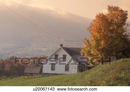 Stock Image -  fog, fall, Danby Four Corners, VT, Vermont, White farmhouse and scenic countryside in the fog in autumn in Danby Four Corners.. Fotosearch