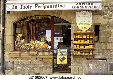 Stock Photo -  France, food, Perigord, Dordogne, Aquitaine, Europe, Sarlet-la-Caneda, A store front in the medieval village of Sarlet-la-Caneda displays foie gras (goose liver). . Fotosearch