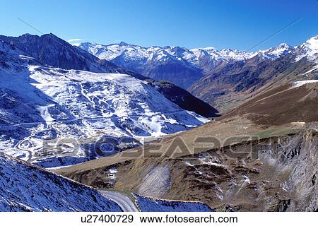 Stock Photo -  France, Midi-Pyrenees, The Pyrenees, Col du Tourmalet, Hautes-Pyrenees, Europe, mountain road, snow capped mountains, Pyrenees Mountains, valley. Fotosearch