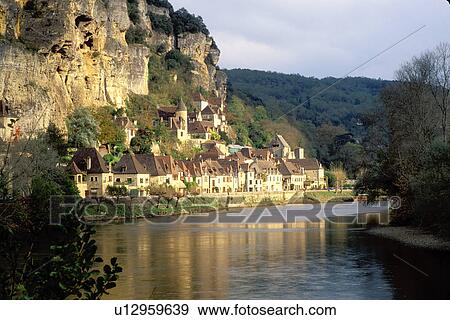 Stock Photo -  France, Perigord, Dordogne, La Roque Gageac, Aquitaine, Europe, The medieval village of La Roque Gageac is nestled under a limestone cliffs along the bank of the Dordogne River.. Fotosearch