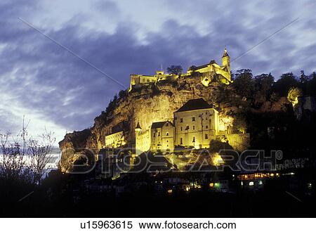 Stock Photography -  France, Perigord, Rocamadour, Dordogne, Lot, Midi-Pyrenees, Europe, pilgrimage town, medieval village, limestone cliffs, illuminated, evening . Fotosearch