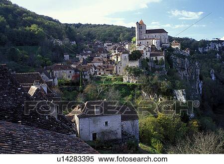 Stock Photography -  France, the Dordogne, Perigord, Quercy, Europe, Midi-Pyrenees, Lot, Saint Cirq-Lapapie, A medieval castle and village of Saint Cirq-Lapapie sit above the rocky cliffs. . Fotosearch