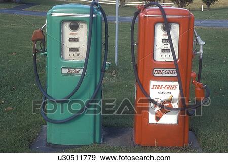 Stock Photo -  gas pumps, antique, collectibles, A red and green pair of Texaco gas pumps stand outside a garage in Berlin in Washington County in the state of Vermont.. Fotosearch
