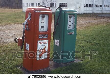 Stock Photograph -  gas pumps, antique, collectibles, A red and green pair of old Texaco gas pumps stand outside a garage in Berlin in Washington County in the state of Vermont.. Fotosearch