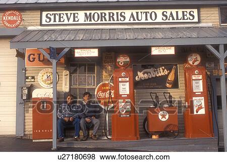 gas station, antique, gas pump, garage, collectibles, Father and son sit on the front porch of Steve Morris Garage and Auto Sales in Orange in Orange County in the state of Vermont. View Large Photo Image Stock Photo - gas station, antique, gas pump, garage, collectibles, Father and son sit on the front porch of Steve Morris Garage and Auto Sales in Orange in Orange County in the state of Vermont.. Fotosearch