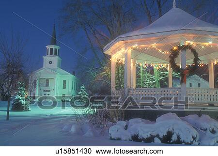 Stock Image -  gazebo, church, chapel, decorations, Christmas, holiday, winter scene, town, winter, snow, Vermont, The First Baptist Church and Gazebo on the Green are decorated for the Christmas holiday season on a snow covered night in the village of Bristol in Addis. Fotosearch