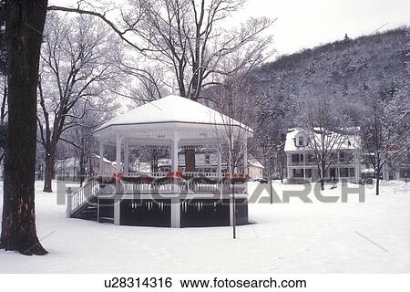 Stock Photograph -  gazebo, holiday, winter, Christmas, ribbon, snow, The snow covered gazebo on the Green is decorated for the Christmas holiday season in the village of Rochester in Windsor County in the state of Vermont. . Fotosearch