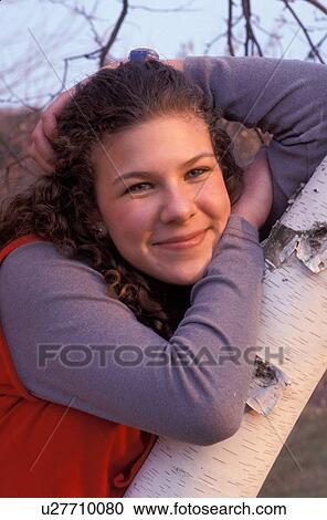 Stock Image -  girl, teenager, Teenage girl poses next to a birch tree for a picture in Montpelier Vermont, VT. Fotosearch