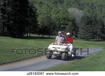 Stock Photo -  golf, cart, spring, Northfield, VT, Vermont, Senior men riding in golf cart at Northfield Golf Course in Northfield in the spring.. Fotosearch