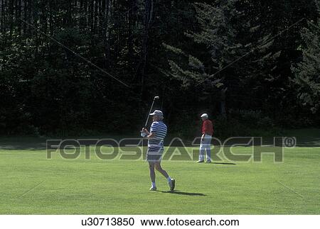 Stock Image -  golf, spring, Northfield, VT, Vermont, Senior men playing golf at Northfield Golf Course in Northfield in the spring.. Fotosearch