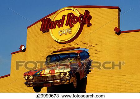 Stock Image -  Hard Rock CafT, Niagara Falls, NY, New York, Front of and old Cadillac mounted on the fatade of the Hard Rock CafT building in Niagara Falls.. Fotosearch