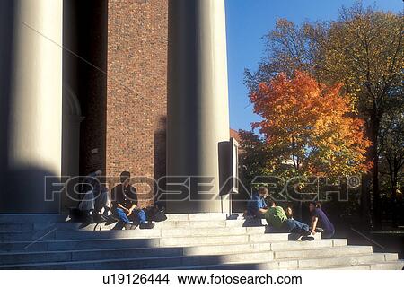 Picture -  Harvard, church, university, Cambridge, MA, Massachusetts, Students sitting on the steps of Memorial Chapel on the campus of Harvard University in Cambridge in the fall. . Fotosearch