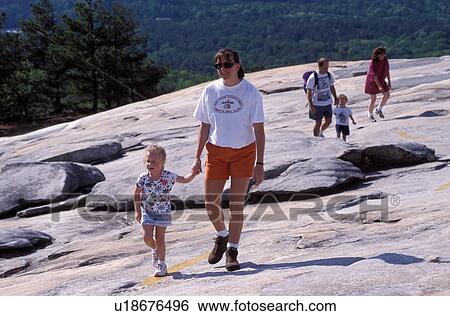Stock Photograph -  hiking, family, Stone Mountain, Georgia's Stone Mountain Park, GA, Atlanta, Georgia, Mother and daughter, father and son walking up to the summit of Stone Mountain (largest granite rock in the world) in Georgia's Stone Mountain Park. . Fotosearch