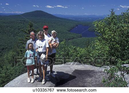 hiking, spring, Groton State Forest, VT, Vermont, Family poses for picture on top of Owl's Head overlooking Kettle Pond in Groton State Forest in the spring. View Large Photo Image Stock Photo - hiking, spring, Groton State Forest, VT, Vermont, Family poses for picture on top of Owl's Head overlooking Kettle Pond in Groton State Forest in the spring.. Fotosearch