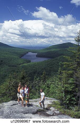 hiking, spring, Groton State Forest, VT, Vermont, Family poses for picture on top of Owl's Head overlooking Kettle Pond in Groton State Forest in the spring. View Large Photo Image Stock Photo - hiking, spring, Groton State Forest, VT, Vermont, Family poses for picture on top of Owl's Head overlooking Kettle Pond in Groton State Forest in the spring.. Fotosearch