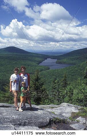 Stock Photography -  hiking, spring, Groton State Forest, VT, Vermont, Girls posing for picture on top of Owl's Head overlooking Kettle Pond in Groton State Forest in the spring.. Fotosearch