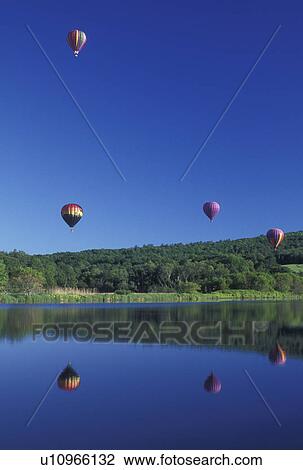 hot air balloon, Vermont, VT, Quechee, Hot air balloons fly above the water at the Quechee Hot Air Balloon Festival. View Large Photo Image Stock Image - hot air balloon, Vermont, VT, Quechee, Hot air balloons fly above the water at the Quechee Hot Air Balloon Festival.. Fotosearch