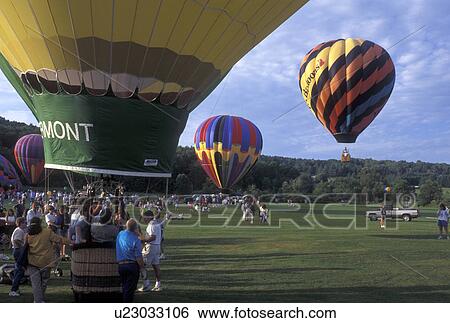 Stock Photograph -  hot air balloon, Vermont, VT, Stowe, The Vermont hot air balloon and others getting ready for take off at the Stoweflake Hot Air Balloon Festival.. Fotosearch