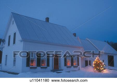 Stock Image -  House, decorations, home, Christmas, holiday, snow, winter, A house in West Topsham is decorated for the Christmas holiday season at night in Orange County in the state of Vermont. . Fotosearch