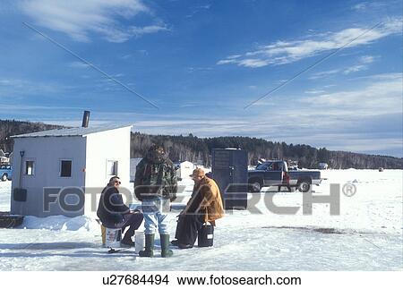 ice fishing, frozen lake, winter, Seymour Lake, VT, Vermont, Three men talking next to a fishing shanty while ice fishing on frozen Lake Seymour on a sunny day in winter. View Large Photo Image Picture - ice fishing, frozen lake, winter, Seymour Lake, VT, Vermont, Three men talking next to a fishing shanty while ice fishing on frozen Lake Seymour on a sunny day in winter. . Fotosearch