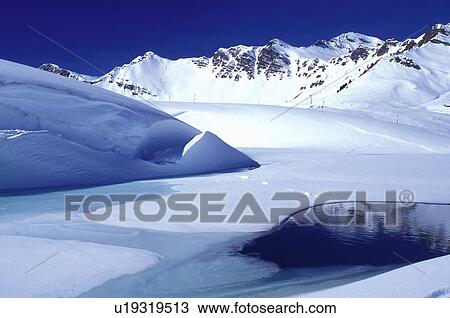 ice, snow, mountains, water, Alps, Switzerland, Valais, Les Crosets, Portes du Soleil, Swiss Alps, Europe, Turquoise colored ice forms on a pond high in the Swiss Alps in the winter. View Large Photo Image Stock Image - ice, snow, mountains, water, Alps, Switzerland, Valais, Les Crosets, Portes du Soleil, Swiss Alps, Europe, Turquoise colored ice forms on a pond high in the Swiss Alps in the winter.. Fotosearch