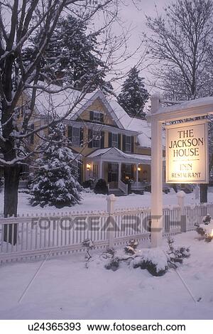 Stock Image -  inn, B&B, country inn, lodge, lodging, hotel, winter, Woodstock, evening, snow, The charming Jackson House Inn & Restaurant (a Country Inn) on a snow covered wintry evening in West Woodstock in Windsor County in the state of Vermont. . Fotosearch