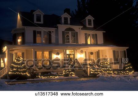 Stock Photo -  Inn, B&B, Hotel, Christmas, holiday, vacation, winter, Vermont, Christmas lights decorate the outside of the Manchester Inn on a snow covered night in winter in Manchester Village in Bennington County in the state of Vermont. . Fotosearch