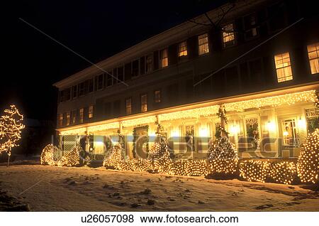 Stock Photo -  inn, B&B, hotel, Christmas, holiday, vacation, Vermont, decorations, winter, Christmas lights illuminate The Village Country Inn on a snow covered night in winter in Manchester Village in Bennington County in the state of Vermont. . Fotosearch