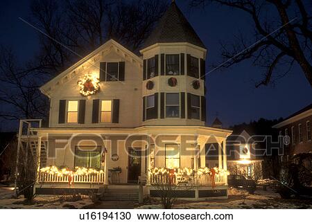 Stock Image -  inn, B&B, hotel, holiday, Christmas, decorations, R&R, vacation, winter, snow, village, evening, Vermont, The Hugging Bear Inn and Shop is beautifully decorated for the Christmas holiday season at night in the town of Chester in Windsor County in the sta. Fotosearch