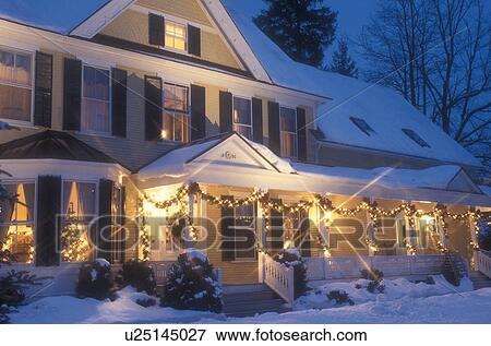 Stock Photo -  Inn, Hotel, country inn, B&B, resort, decorations, holiday, Christmas, snow, winter, The Jackson House Inn (a Country Inn) is decorated with white lights for the Christmas holiday season at night in West Woodstock in Windsor County in the state of Vermon. Fotosearch