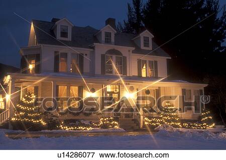 Stock Photo -  inn, resort, hotel, B&B, Manchester, Vermont, Christmas, decorations, holiday, evening, snow, winter, The Inn at Manchester (a Country Inn) is decorated with lights for the Christmas holiday season at night in Manchester Village in Bennington County in t. Fotosearch