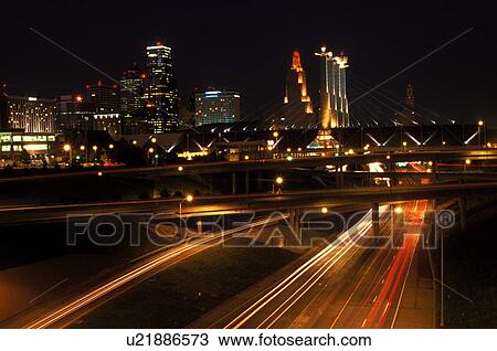 Stock Image -  Kansas City, skyline, expressway, MO, Missouri, downtown skyline of Kansas City and I-670/I-35 at night.. Fotosearch