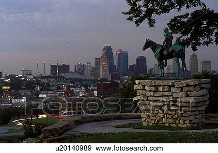 Kansas City, skyline, MO, Missouri, A bronze statue of Indian Scout overlooks the downtown skyline of Kansas City from Penn Valley Park in the evening. View Large Photo Image Stock Photo - Kansas City, skyline, MO, Missouri, A bronze statue of Indian Scout overlooks the downtown skyline of Kansas City from Penn Valley Park in the evening.. Fotosearch