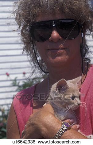 Stock Photograph -  kitten, Woman holding kitten.. Fotosearch