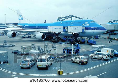 Stock Image -  KLM, airport, Schiphol, Amsterdam, The Netherlands, Holland, Europe, KLM Royal Dutch Airline passenger plane is parked outside the terminal at Schiphol International Airport in Amsterdam.. Fotosearch