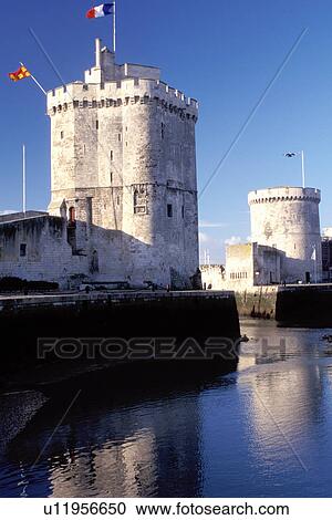 Stock Image -  La Rochelle, France, Poitou-Charentes, Charente-Maritime, Europe, 14th century medieval stone towers at the entrance to the harbor of the ancient fortified old port city of La Rochelle on the Atlantic Ocean.. Fotosearch