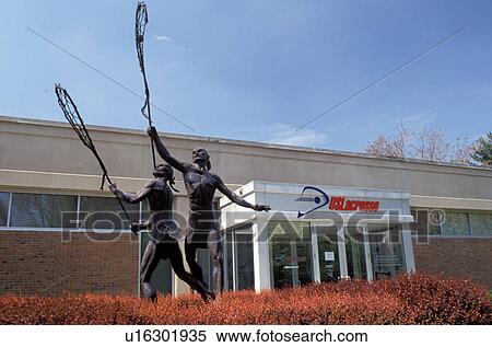 Stock Photography -  Lacrosse, Hall of Fame, Baltimore, US Lacrosse Hall of Fame Museum, Maryland, Statue of Indians playing Lacrosse in front of the US Lacrosse Hall of Fame Museum.. Fotosearch