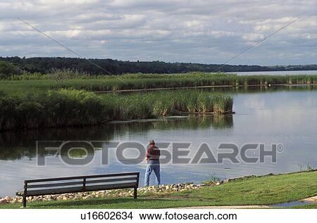 lake, fishing, Continental Divide, MN/SD, Minnesota, South Dakota, Minnesota River, Man fishing on Traverse Lake along the Continental Divide in Browns Valley indicating the flow of the rivers to the Gulf of Mexico and to the Hudson Bay. View Large Photo Image Picture - lake, fishing, Continental Divide, MN/SD, Minnesota, South Dakota, Minnesota River, Man fishing on Traverse Lake along the Continental Divide in Browns Valley indicating the flow of the rivers to the Gulf of Mexico and to the Hudson Bay.. Fotosearch