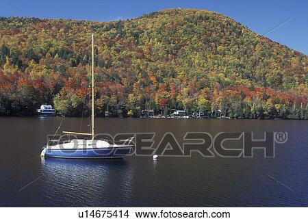 Picture -  lake, sailboat, fall, Barnet, VT, Vermont, Sailboat buoyed on Harveys Lake in the autumn.. Fotosearch