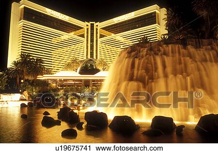 Stock Image -  Las Vegas, Nevada, The Mirage, casino, NV, The Strip, Volcano eruption in the lagoon at The Mirage Hotel & Casino on The Strip at night in Las Vegas, the Entertainment Capital of the World.. Fotosearch