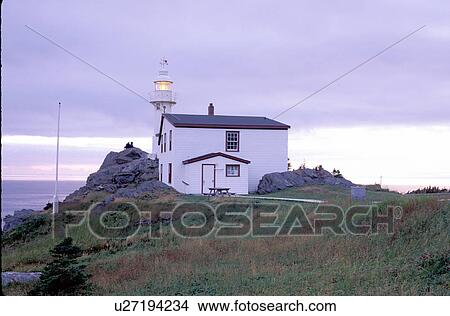 Picture -  lighthouse, Newfoundland, NF, Canada, Lobster Cove Head Lighthouse on the Gulf of St. Lawrence at sunset. Gros Morne National Park.. Fotosearch