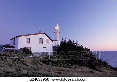 Stock Photograph -  lighthouse, Newfoundland, NF, Canada, Lobster Cove Head Lighthouse on the Gulf of St. Lawrence at sunset. Gros Morne National Park.. Fotosearch