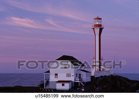 Stock Photo -  lighthouse, Nova Scotia, Yarmouth, NS, Canada, Cape Forchu Lighthouse at sunrise along the coast in Yarmouth on the Atlantic Ocean. . Fotosearch
