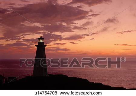 Stock Photo -  lighthouse, sunrise, sunset, Newfoundland, NF, Canada, Lighthouse at Cape Spear National Historic Site, Easternmost Point of North America at sunrise on the Atlantic Ocean.. Fotosearch