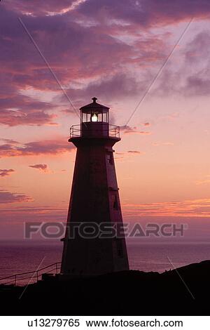 Stock Photography -  lighthouse, sunrise, sunset, Newfoundland, NF, Canada, Lighthouse at Cape Spear National Historic Site, Easternmost Point of North America at sunrise on the Atlantic Ocean.. Fotosearch