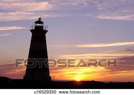 Stock Image -  lighthouse, sunset, sunrise, Nova Scotia, Bay of Fundy, NS, Canada, Western Lighthouse at sunset along the coast of the Bay of Fundy on Briar Island on the Atlantic Ocean. . Fotosearch