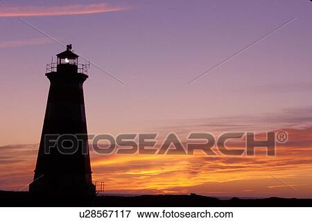 Stock Photo -  lighthouse, sunset, sunrise, Nova Scotia, Bay of Fundy, NS, Canada, Western Lighthouse at sunset along the coast of the Bay of Fundy on Briar Island on the Atlantic Ocean. . Fotosearch