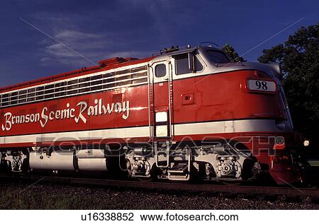 Stock Image -  locomotive, train, scenic railway, Branson, MO, Missouri, A powerful red locomotive pulls the train at the Branson Scenic Railway in Branson.. Fotosearch