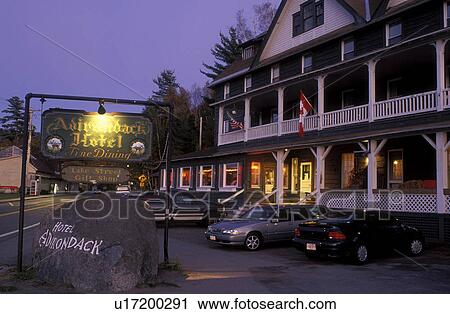 Stock Image -  lodging, hotel, inn, Adirondacks, Long Lake, New York, NY, Adirondack Hotel in the evening at Long Lake in the Adirondacks.. Fotosearch